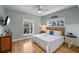 Comfortable bedroom with queen bed, wood floors, and plenty of natural light at 204 66Th Street, Holmes Beach, FL 34217