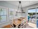 Charming dining room with rustic wooden table, seating for eight, and a view from the balcony at 204 66Th Street, Holmes Beach, FL 34217