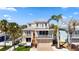 Stunning two-story home boasts multiple balconies, lush landscaping, and a charming coastal aesthetic at 204 66Th Street, Holmes Beach, FL 34217