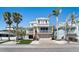 Charming 2-story home with a covered garage, balconies, and a well-manicured lawn surrounded by palm trees at 204 66Th Street, Holmes Beach, FL 34217