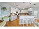 Bright kitchen with stainless steel appliances, white cabinets and an island with counter seating at 204 66Th Street, Holmes Beach, FL 34217