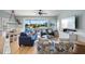 Relaxing living area featuring a large window with sliding glass doors, comfortable seating, and coastal decor at 204 66Th Street, Holmes Beach, FL 34217
