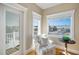 Cozy sitting area with a starfish patterned chair, balcony access, and view of the neighborhood at 204 66Th Street, Holmes Beach, FL 34217
