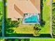 Clean aerial shot of a house, surrounded by lush grass, showing a refreshing screened-in pool at 2247 Otter Creek Ln, Sarasota, FL 34240