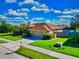 Well-maintained home with a two-car garage, lush lawn, and fenced yard offers privacy and curb appeal at 2247 Otter Creek Ln, Sarasota, FL 34240