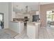 Bright kitchen featuring white cabinetry and a breakfast bar with tile floors at 2247 Otter Creek Ln, Sarasota, FL 34240