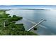 Stunning aerial view featuring a long pier extending into the tranquil waters and lush shoreline at 2625 Terra Ceia Bay Blvd # 504, Palmetto, FL 34221