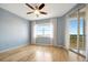 Bedroom features water view, ceiling fan, and sliding glass doors to balcony at 2625 Terra Ceia Bay Blvd # 504, Palmetto, FL 34221