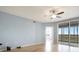 Bright bedroom featuring hardwood floors, ceiling fan, and sliding glass doors leading to the screened-in lanai at 2625 Terra Ceia Bay Blvd # 504, Palmetto, FL 34221