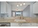 An open kitchen with granite counters and a view into the living area and outdoor scenery at 2625 Terra Ceia Bay Blvd # 504, Palmetto, FL 34221