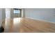 Spacious living room boasts gleaming hardwood floors and abundant natural light from the screened-in lanai at 2625 Terra Ceia Bay Blvd # 504, Palmetto, FL 34221