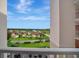 Balcony view overlooking lush landscaping, a tranquil lake, and residential community at 2625 Terra Ceia Bay Blvd # 504, Palmetto, FL 34221