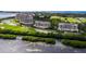 An aerial view showcasing luxury condos near lush golf courses, waterfront views, and serene landscaping at 3010 Grand Bay Blvd # 482, Longboat Key, FL 34228
