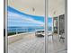 Large tiled balcony with ocean view and comfortable seating, accessible through sliding glass doors at 3010 Grand Bay Blvd # 482, Longboat Key, FL 34228
