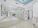 Bright bathroom featuring a bathtub, glass shower, and modern fixtures at 3010 Grand Bay Blvd # 482, Longboat Key, FL 34228