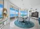 Elegant dining room with waterfront views, modern chandelier, and seating for six at 3010 Grand Bay Blvd # 482, Longboat Key, FL 34228