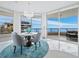 Bright dining area with floor-to-ceiling windows, chandelier, and seating for six at 3010 Grand Bay Blvd # 482, Longboat Key, FL 34228