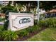 Grand Bay entrance sign surrounded by beautiful landscaping and seasonal holiday decor at 3010 Grand Bay Blvd # 482, Longboat Key, FL 34228