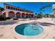 Exterior hot tub area showcasing the spa with nearby lounge seating, tropical greenery and the condominium at 3010 Grand Bay Blvd # 482, Longboat Key, FL 34228