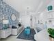 Stylish living area with blue patterned wallpaper, modern furniture, and bright lighting at 3010 Grand Bay Blvd # 482, Longboat Key, FL 34228