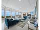 Bright living room with floor-to-ceiling windows offering panoramic views, and modern decor at 3010 Grand Bay Blvd # 482, Longboat Key, FL 34228