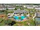 Aerial view of a community clubhouse featuring a sparkling pool with ample seating and lush landscaping at 3375 Chestertown Loop, Lakewood Ranch, FL 34211