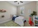 Neutral bedroom with a single bed, ceiling fan, and a sunny window at 3375 Chestertown Loop, Lakewood Ranch, FL 34211