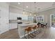 Beautiful kitchen with a granite island, stainless steel appliances and three pendant lights above the island at 3375 Chestertown Loop, Lakewood Ranch, FL 34211