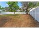 Large, fenced backyard with mature trees providing shade and privacy, perfect for outdoor activities at 3457 50Th N Ave, St Petersburg, FL 33714
