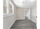Bright bedroom with gray wood-look floors, white door and trim and multiple windows at 3457 50Th N Ave, St Petersburg, FL 33714