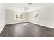 Bright bedroom features modern ceiling fan, neutral paint, and durable gray laminate flooring at 3457 50Th N Ave, St Petersburg, FL 33714