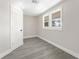 Light-filled bedroom has gray wood-look flooring, a white door and windows at 3457 50Th N Ave, St Petersburg, FL 33714