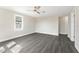 Bright bedroom features modern ceiling fan, neutral paint, and durable gray laminate flooring at 3457 50Th N Ave, St Petersburg, FL 33714