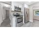 Modern kitchen featuring stainless steel appliances and gray laminate flooring at 3457 50Th N Ave, St Petersburg, FL 33714