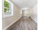 Spacious living room with updated gray wood floors and fresh paint, ready for your personal touches at 3457 50Th N Ave, St Petersburg, FL 33714