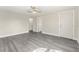 Spacious living room featuring durable gray laminate flooring, neutral paint and two entry doorways at 3457 50Th N Ave, St Petersburg, FL 33714
