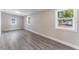 Bright and airy living room with modern gray wood floors and natural light from multiple windows at 3457 50Th N Ave, St Petersburg, FL 33714