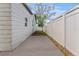 Concrete side yard with white fence offers clean, low-maintenance space next to house at 3457 50Th N Ave, St Petersburg, FL 33714