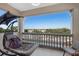 Relaxing condo balcony with comfortable seating, a sunshade, and views of the community at 3730 Cadbury Cir # 414, Venice, FL 34293