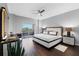 Luxurious main bedroom with modern lighting, a balcony access, and stylish decor at 3730 Cadbury Cir # 414, Venice, FL 34293