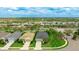 Beautiful aerial view of single-Gathering homes in a well-maintained neighborhood with lush green landscaping and mature trees at 3839 Autumn Fern Ter, Sarasota, FL 34243