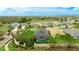 Aerial shot of a landscaped property with a screened pool, complemented by mature trees at 3839 Autumn Fern Ter, Sarasota, FL 34243