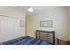This bedroom features a large closet, ceiling fan, and dresser with nautical wall decor at 3839 Autumn Fern Ter, Sarasota, FL 34243