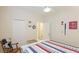 This bedroom has nautical decor, a ceiling fan, and a striped quilt at 3839 Autumn Fern Ter, Sarasota, FL 34243