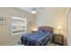 Cozy bedroom with a woven headboard, ceiling fan and natural light at 3839 Autumn Fern Ter, Sarasota, FL 34243