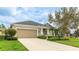 Lovely single-story home with a two-car garage, a well-kept lawn, and mature trees at 3839 Autumn Fern Ter, Sarasota, FL 34243