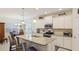 Modern kitchen boasting white cabinetry, granite counters, and stainless steel appliances at 3839 Autumn Fern Ter, Sarasota, FL 34243