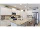 Bright kitchen featuring white cabinets, stainless steel appliances, and granite countertops at 3839 Autumn Fern Ter, Sarasota, FL 34243