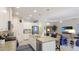 An open-concept kitchen with stainless appliances, a center island, and adjacent living area at 3839 Autumn Fern Ter, Sarasota, FL 34243