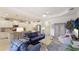 Comfortable open-concept living room with tile floors, ceiling fan, and bright white kitchen at 3839 Autumn Fern Ter, Sarasota, FL 34243